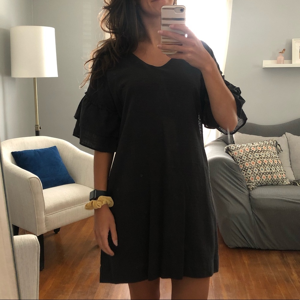 Dark grey dress with ruffle sleeves.